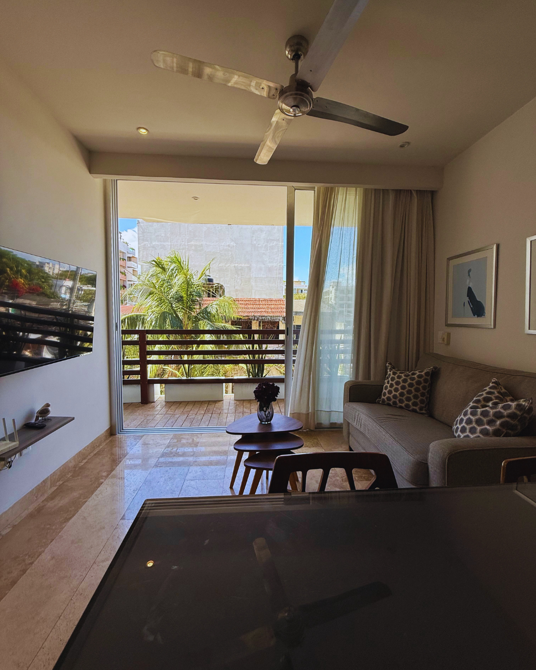 Bright living area in Tropic Playa apartment, Playa del Carmen, featuring a private balcony with natural light and a modern design.