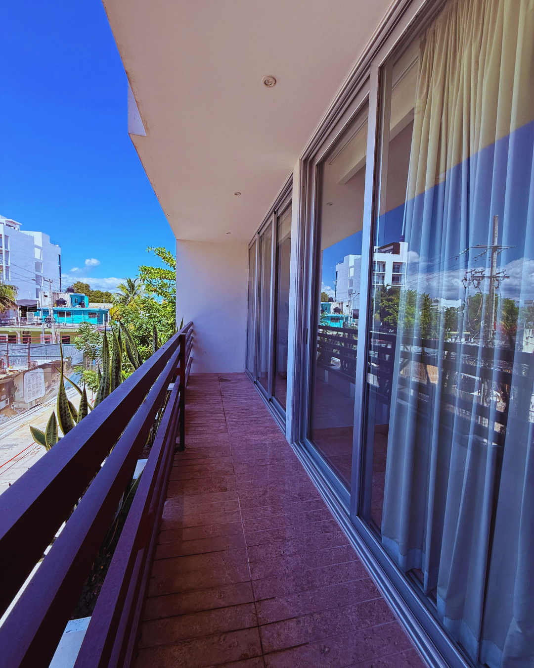 Private balcony with city views in a fully furnished long-term rental apartment in Playa del Carmen.