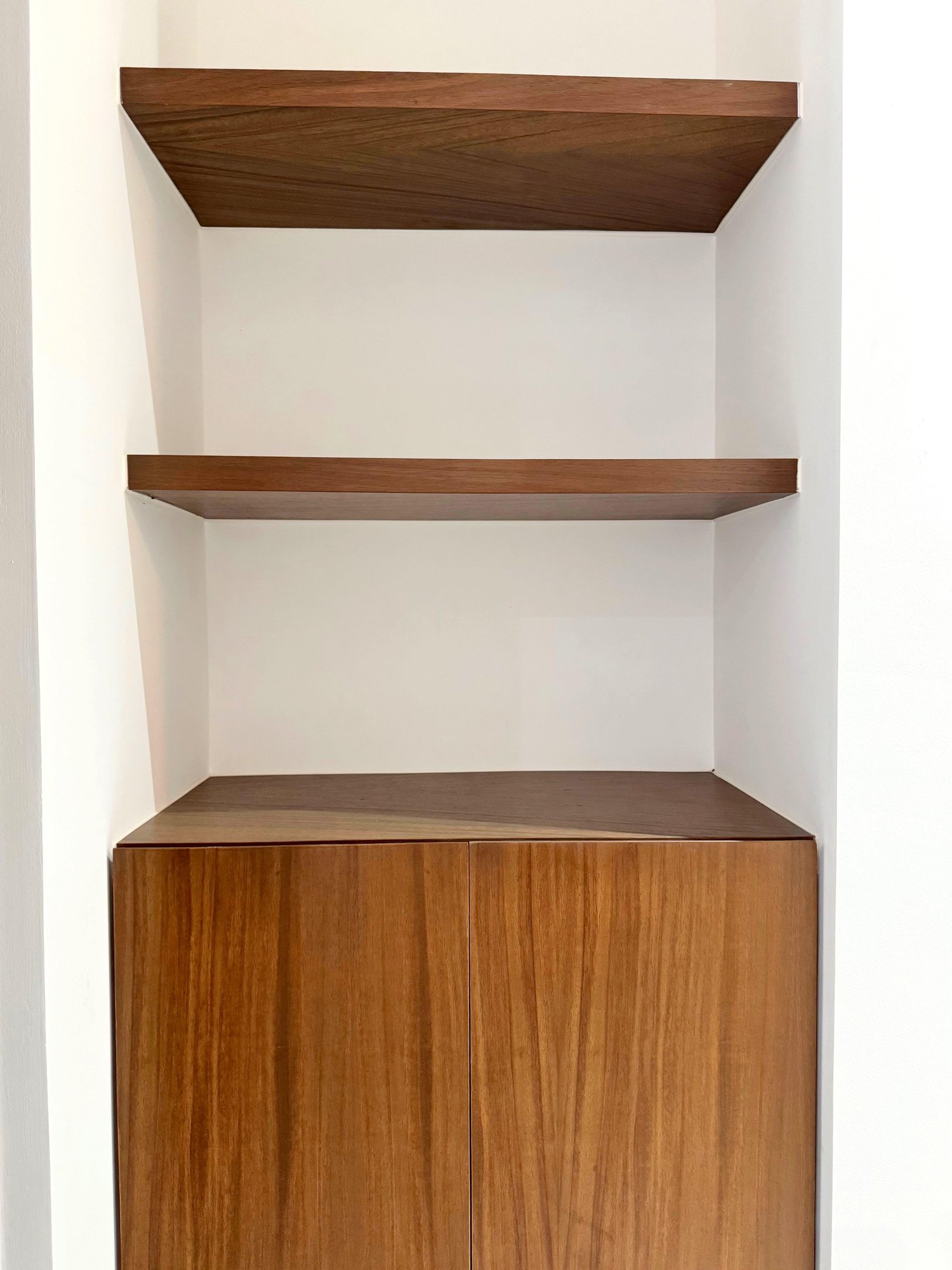 Built-in wooden shelves with storage cabinet in a modern furnished apartment for rent in Playa del Carmen – La Selva Residences