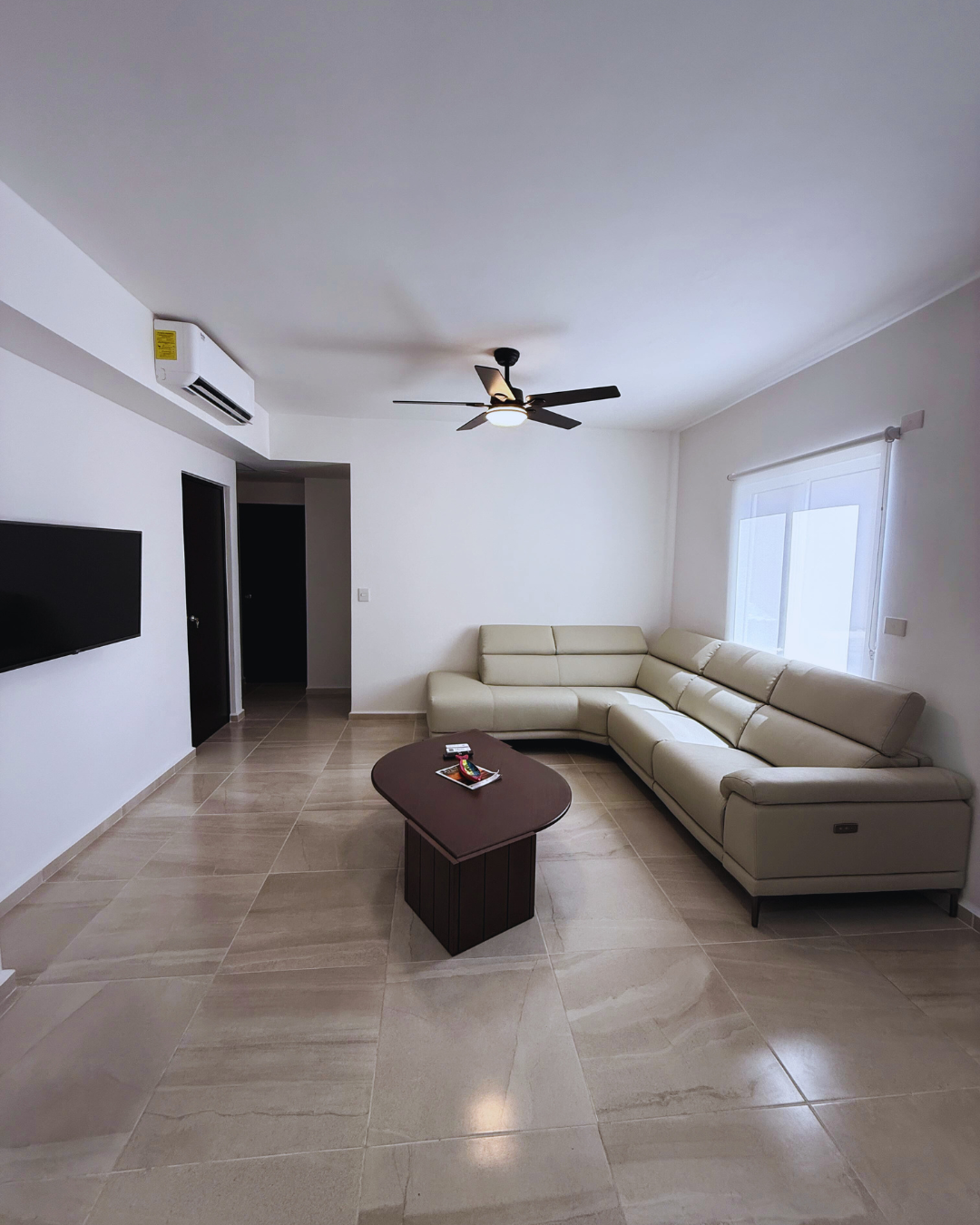 Furnished living room with air conditioning and TV